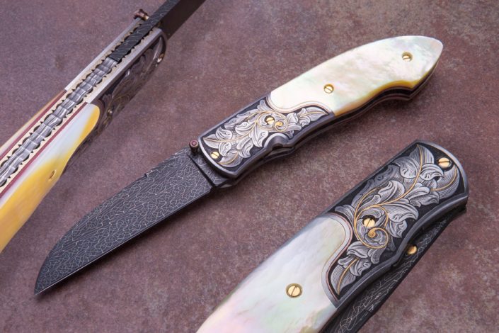 The "Squire" Fitted with a 3" Doug Ponzio Turkish Twist Damascus blade, Gold Lip Mother of Pearl Scales, 24ct gold engraving by Joe Mason, with fileworked, jeweled, & anodized titanium liners, with fileworked Damascus backspacer. $3995. CLick on image for Hi-Res Imageview.